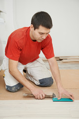carpenter worker joining parket floor