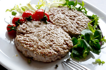 Juicy grilled hamburgers  with salad and green beans