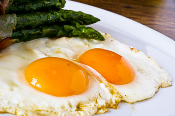 Asparagi with fried egg brown