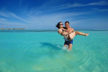 happy young  couple enjoying summer on beach