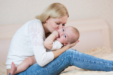 mother playing with baby boy indoors