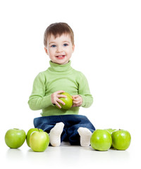 Fototapeta premium happy baby boy with green apples isolated on white background