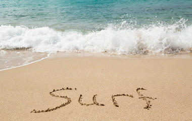 Drawing in sand by ocean of surf word