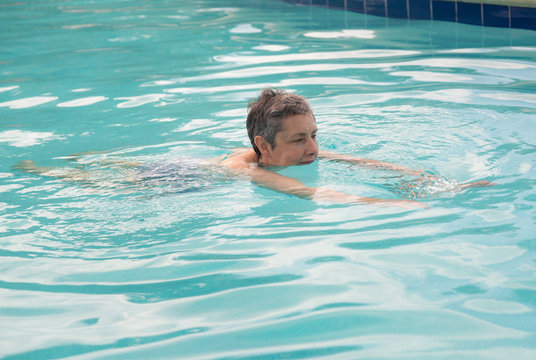 Senior Lady Swimming In Pool