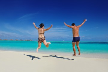 happy young  couple enjoying summer on beach