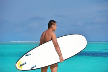 Man with surf board on beach