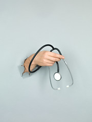 male hand holding stethoscope