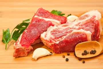 Raw beef with spices and vegetables on the cutting board