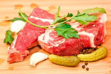 Raw beef with spices and vegetables on the cutting board