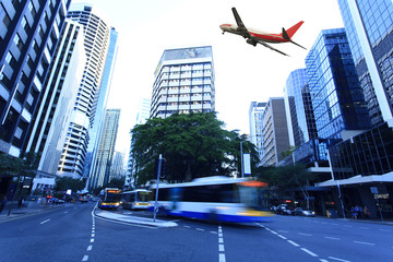 Modern city buildings and aircraft in Brisbane - obrazy, fototapety, plakaty
