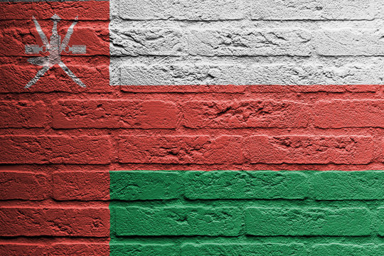 Brick wall with a painting of a flag, Oman
