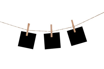 Blank paper cards hanging on clothespins 