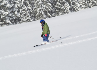 child skiing in powder snow