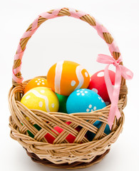 Colorful painted easter eggs in basket isolated