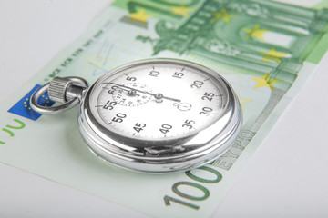 Stopwatch and a hundred euro banknote.  Closeup