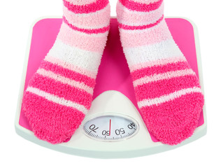 Feet on scales isolated on white