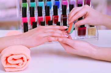 Manicure process in beauty salon, close up