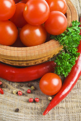 Tomato and red hot chili peppers in old mortar