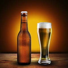 bottle and glass of beer on wood table