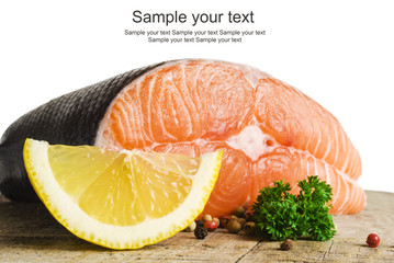 raw salmon with lemon and spices on an old wooden table
