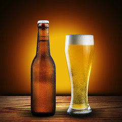 bottle and glass of beer on wood table