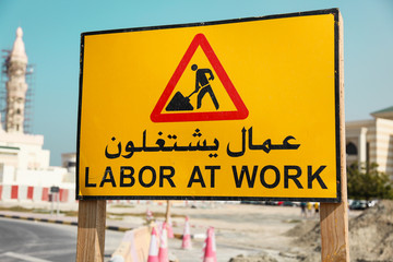 Labor at Work writen on a arab and english language