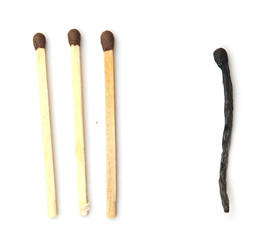 Close-up of a burnt match and a whole brown match isolated on a