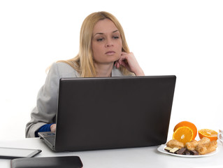 woman with laptop and fresh oranges