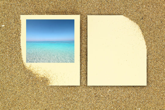 Photo frame and paper card on the sand