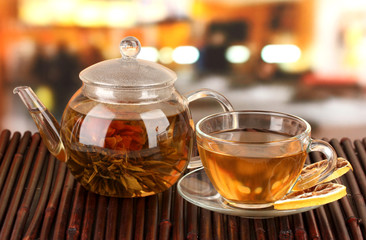 Exotic green tea with flowers in glass teapot