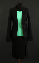 Turquoise blouse and black skirt with coat