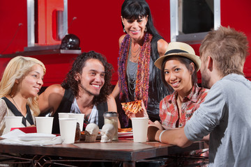 Woman Eating Pizza with Friends