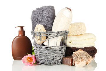 Composition of cosmetic bottles and soap in basket, isolated