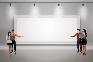 Business couple presentation on blank billboard
