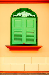 Colorful wall with green window
