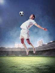 Zelfklevend Fotobehang voetballer die de bal slaat © Sergey Nivens