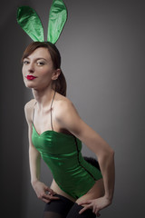 Young woman in green corset with white bunny ears