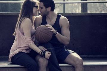 Beautiful young couple, kissing after physical activity