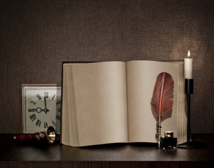 vintage book, pen, watch and candle