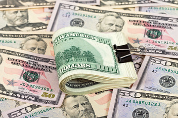 Stack of one hundred dollar bills row on money background