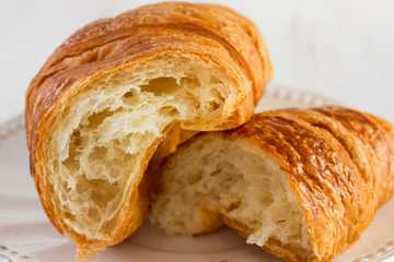 cut croissant on white table