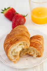 croissant with strawberry and orange juice