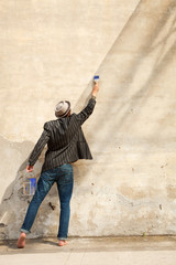 man  writes on a wall