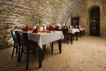 romantic arch stonewall in knight room with tables and candlelit