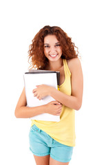 Fototapeta premium College girl holding books and smiling