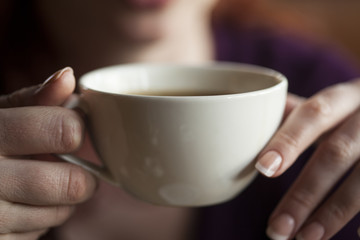 Fototapeta na wymiar Woman Holding Her Morning Cup of Coffee