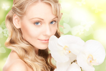 beautiful woman with orchid flower and butterflies