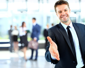 Portrait of a successful businessman giving a hand