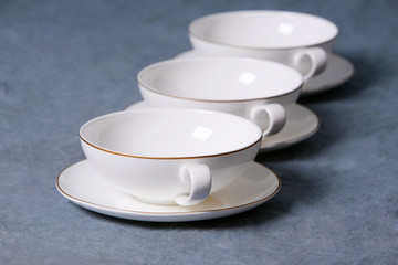 Tassen in Reihe mit Tellern