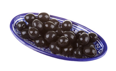 Olives black watered with olive oil in a bowl isolated on a whit